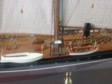 a model of a sailboat on display in a glass case