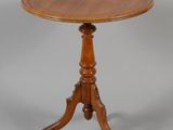 a small wooden table with a wooden top on a grey background