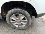 a close up of a tire on a white truck
