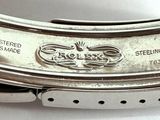 a close up of a watch on a white surface