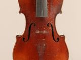 un vieux violon posé sur une surface blanche