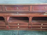 a large wooden cabinet with drawers and drawers on it