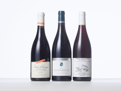 three bottles of wine are lined up on a table