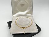 an open box with a necklace and bracelet in it