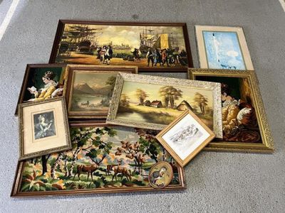 a lot of framed pictures and paintings on the floor