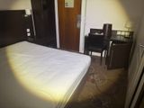 a bed and a desk in a small room