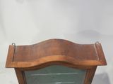 a wooden shelf with a glass door on it