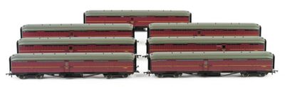 six red and green train cars sitting next to each other