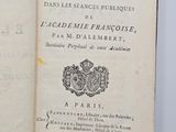 an open book with a picture of a coat of arms on it