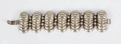 an image of a silver bracelet on a white surface