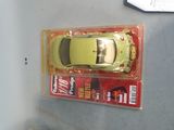 a yellow toy car in a plastic box on a table