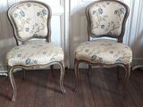 two chairs sitting next to each other on a wooden floor