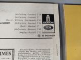 a close up of a newspaper with a picture of a clock