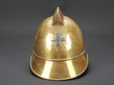 a gold helmet with a cross on it on a gray background