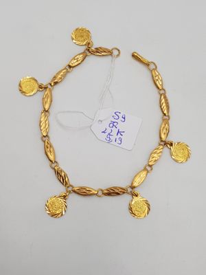 an image of a gold bracelet with coins on it
