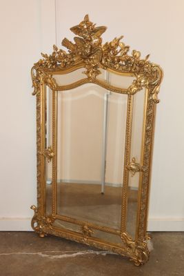 a mirror that is sitting on the floor next to a wall