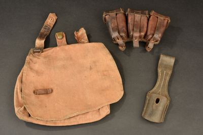 a small bag with a knife and other items on a table