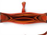 an image of a red purse with a long strap on it