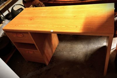 a wooden desk with a drawer underneath it in a room