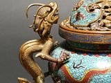 a blue and gold vase with a dragon on top of it