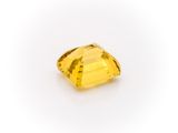a yellow sapphire stone on a white background