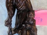 a figurine of a man and a dog on a table