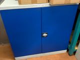 a blue cabinet with two boxes on top of it