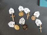 a lot of tags and a cross on a table