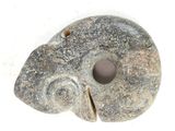 a stone object with a hole in it on a white surface