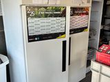 a refrigerator that has a lot of items on the top of it