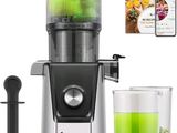 a blender with a glass of green liquid next to it