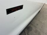 a sticker on the side of a white car