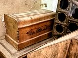 a wooden box sitting on top of a pile of junk