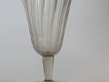 a clear glass cup sitting on top of a white table