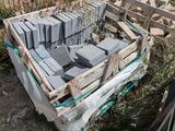 a pile of bricks sitting on a pallet next to a fence