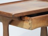 a small wooden table with a drawer on it