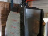 an image of a microwave sitting on top of a cart in a warehouse