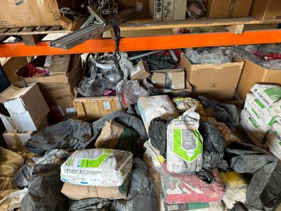 a large pile of boxes and other items in a warehouse