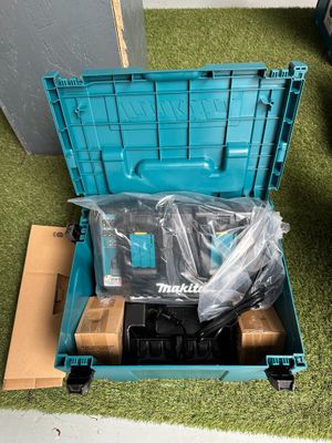 a blue tool box with tools in it sitting on the floor