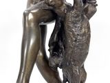 bronze statue of a boy with a dog on a pedestal