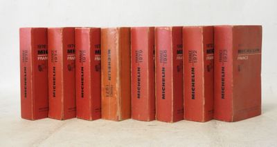 six red books are lined up in a row on a white surface