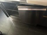 a stainless steel sink and a stainless steel refrigerator in a kitchen