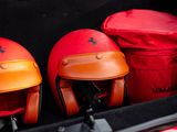 three helmets sitting in the trunk of a car