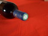 a bottle of wine sitting on a red table cloth