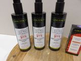 three bottles of olive oil on a cutting board next to a box of chocolate