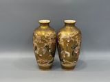 two vases are sitting on a white surface with a gray background