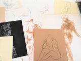many different colored drawings on a table with a pencil