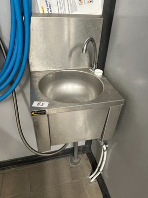 a stainless steel sink with a blue hose attached to it