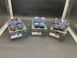 three pairs of baby shoes sitting on top of boxes