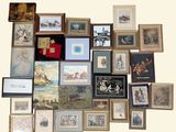 a lot of framed pictures on the wall of this room